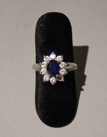 null 750 thousandths gold daisy ring set with a blue stone and small white stones
Gross...