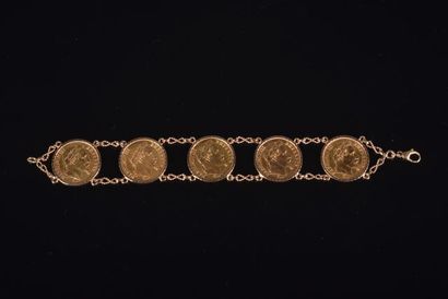 null Bracelet en or jaune serti de cinq pièces de 20 francs or Napoléon III lauré....