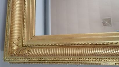 null Grand miroir dans un cadre à canaux en bois stuqué doré. Manques et restaurations....