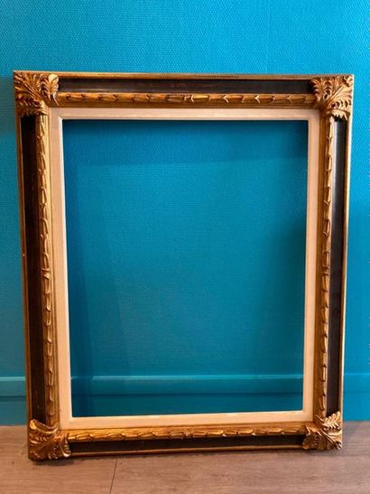 Wooden frame with gilded wood staples in...