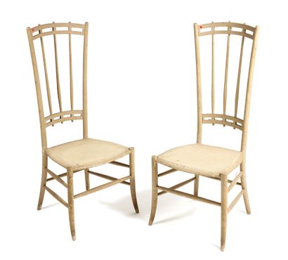 DEUX CHAISES TWO CHAIRS

with high openwork spindle backs in cream lacquered wood....