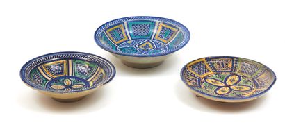 Three earthenware dishes with blue, green...