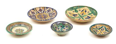 null Five earthenware dishes with polychrome decoration mainly of floral motifs with...