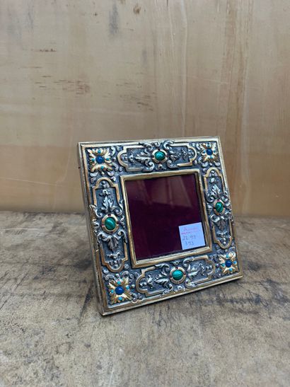 null Embossed and partially gilded silver frame decorated with leaves and foliage...