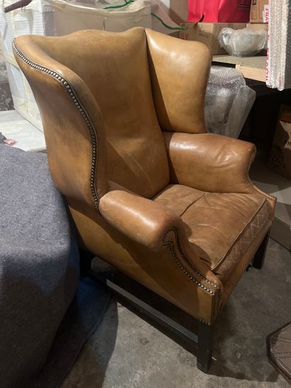 null Club armchair with ears, upholstered in fawn leather with nails, black-stained...