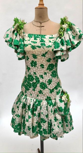 null CARVEN, white silk cocktail dress with green flower print, balloon sleeves adorned...