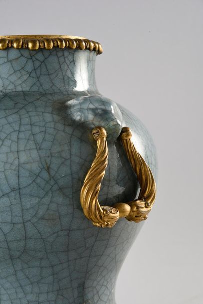 null Blue-grey cracked celadon vase and chiseled and gilded bronze the rim with gadroons...