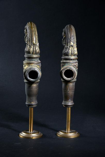 null Pair of chased and gilt bronze taps, the sleeves decorated with scrolls, the...