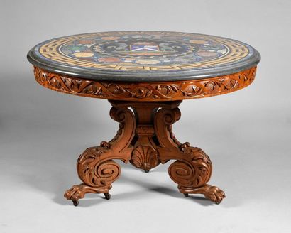 null An important carved walnut pedestal table, resting on three scrolled feet, acanthus...