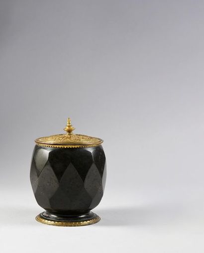 null Serpentine tobacco jar, the gilt copper frame resting on a round base with a...