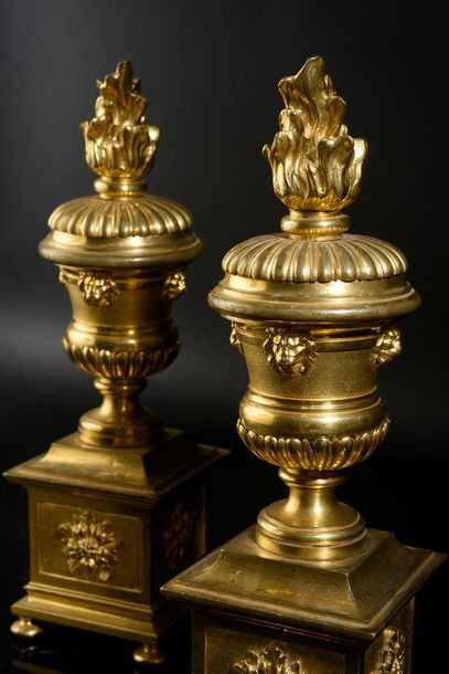 Pair of chiseled and gilt bronze andirons, resting on four raven feet, the square...