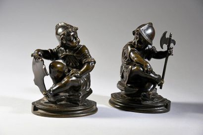  Pair of statuettes of putti symbolizing war in patinated bronze, they are represented...
