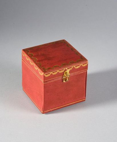 CARTIER. 
Two red leather cases: a flat rectangular case with a neck watch and a...