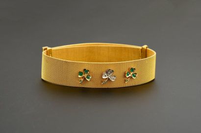 null Woven gold mesh ribbon bracelet, decorated with three gold and silver clovers...