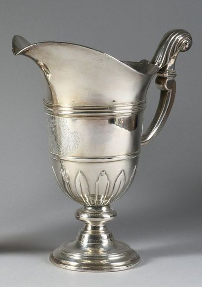 null A silver-plated metal ewer, helmet-shaped, on a pedestal, the base of the body...