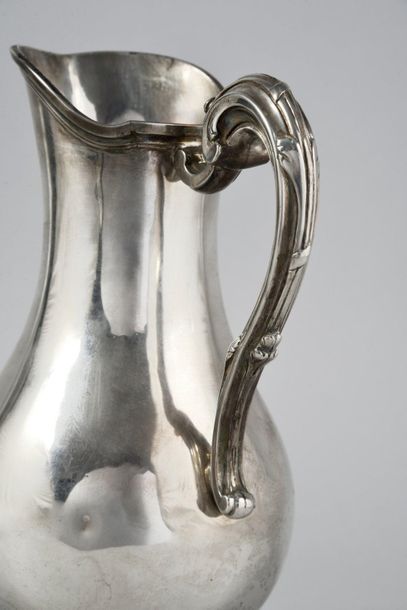 null Silver ewer in the form of a baluster, on a shower base decorated with a ribboned...