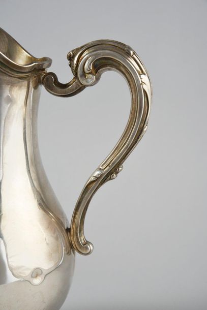 null Silver ewer in the form of a baluster, on a shower base decorated with a ribboned...