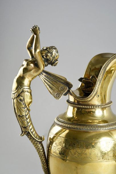 null Ewer and its basin in 950e vermeil.
The ewer rests on a pedestal chiselled with...