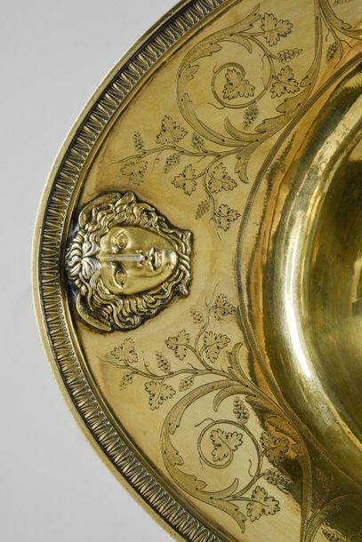 null Ewer and its basin in 950e vermeil.
The ewer rests on a pedestal chiselled with...
