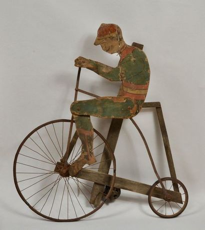 null Big Bi sign. In painted wood with a motor used to animate the rider. Metal wheels...