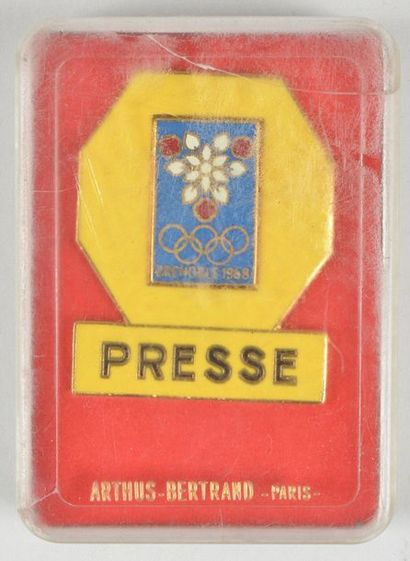 null GRENOBLE 1968. Badge presse doré, émaillé jaune. Dim 35x45 mm. Par Arthus Bertrand....