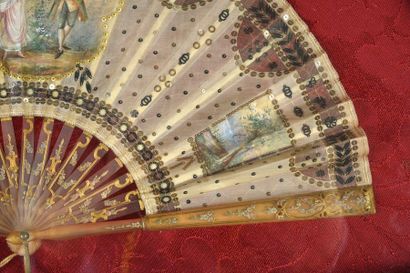 null The gallant, circa 1920
Folded fan, the sheet of fabric and tulle painted with...