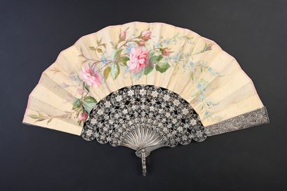 null Silver filigree, circa 1880
Folded fan, the cream satin leaf painted with a...