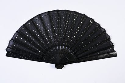 null Sequins, early 20th century
Folded fan, the black fabric leaf embroidered with...