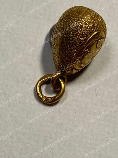  SMALL MINIATURE EGG PENDANT. In gold set with a sugar loaf sapphire. Wear and tear....