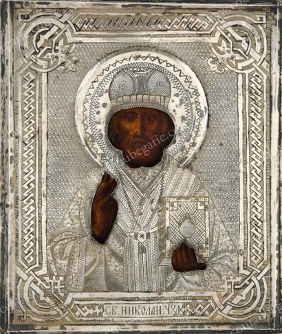  SAINT NICOLAS. Russian icon, tempera on wood, preserved under a silver riza with...
