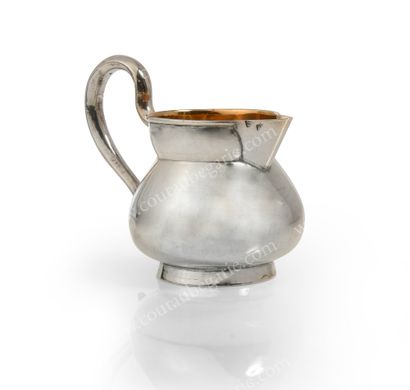 null SMALL UNIQUIDED SILVER CREAM POT.
Of round and domed form, resting on a circular...