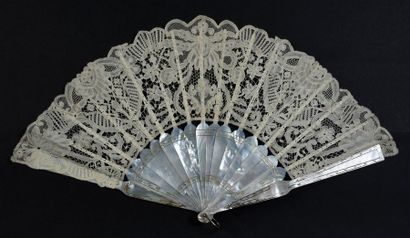 Folded fan made of duchess lace, circa 1900....