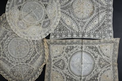 null Meeting of doilies and handkerchiefs, early 20th century.
Four placemats with...