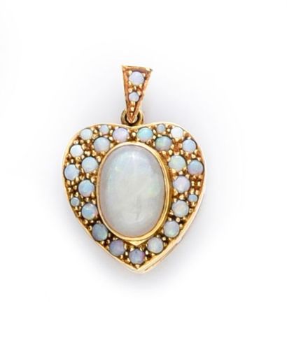 null 750°° gold reliquary pendant stylizing a heart set with an oval opal cabochon...