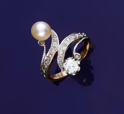 null Two-tone gold ring set with a cultured pearl and an antique cut diamond, the...