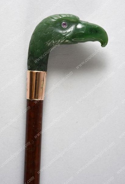 null *CANE WITH POMMEL. 
 Wooden shaft, surmounted by an eagle's head carved from...