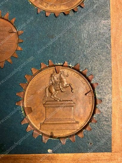 null FRAMEWORK.
Containing five commemorative bronze medals with a brown patina,...