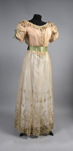 null Evening gown, circa 1900, chiffon embroidered in pink, cream and green silk...