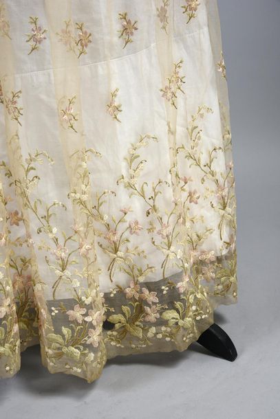 null Evening gown, circa 1900, chiffon embroidered in pink, cream and green silk...