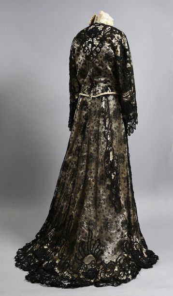 null Dress, circa 1905, cream satin veiled with black mechanical lace with floral...