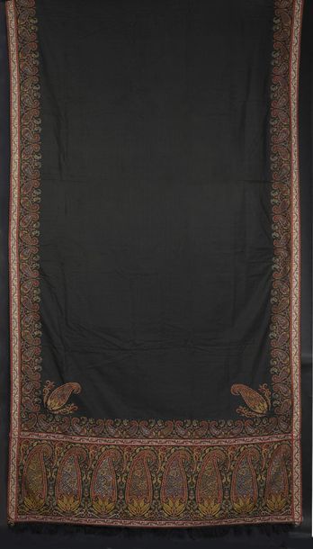 null Long cashmere shawl, circa 1840, plain black field framed with garlands of palmettes...