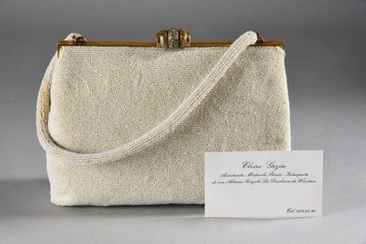 null WALLIS, Duchess of Windsor (1896-1986). 

Bag in white pearl sand, held by a...