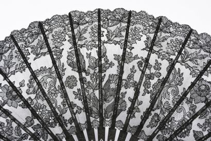 null Scrolls and flowers, circa 1890
Large folded fan, the leaf in black mechanical...