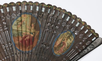 null The Fan Wind, ca. 1790
A broken fan of brown wood, reperced and painted with...