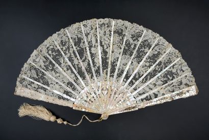  Luxuriance, circa 1890 Fan, the leaf in needle lace, cream-coloured, with rich flower...