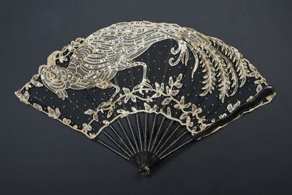 null The silver pheasant, circa 1900-1910
Folded fan, the black tulle leaf decorated...