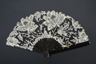null Flowers in full bloom, circa 1900-1910
Folded fan, the black tulle leaf decorated...