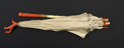  Coral umbrella, circa 1880 Cream silk flag. The handle in ivory*, the touching end...