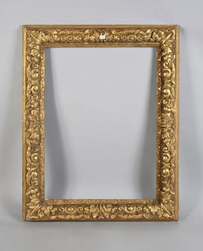 null Gilded carved wood frame decorated with friezes of foliage on a background of...