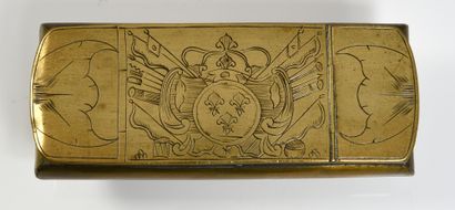 null TOBACCO BOX. Rectangular gilt brass box, the hinged lid is engraved in the center...
